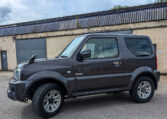 Side view of the 2013 Suzuki Jimny X-Adventure in stunning pearlescent grey with folding side mirrors